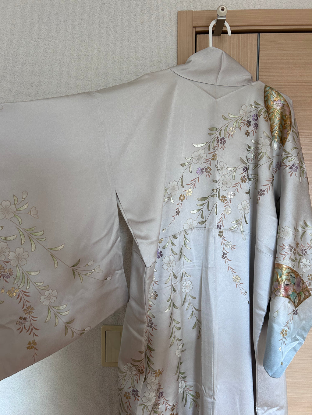 Vintage Japanese silk haori in soft silver with sakura and fan motifs - back view 